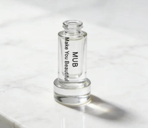 Clear perfume bottle with 'MUB' and 'Make You Beautiful' label