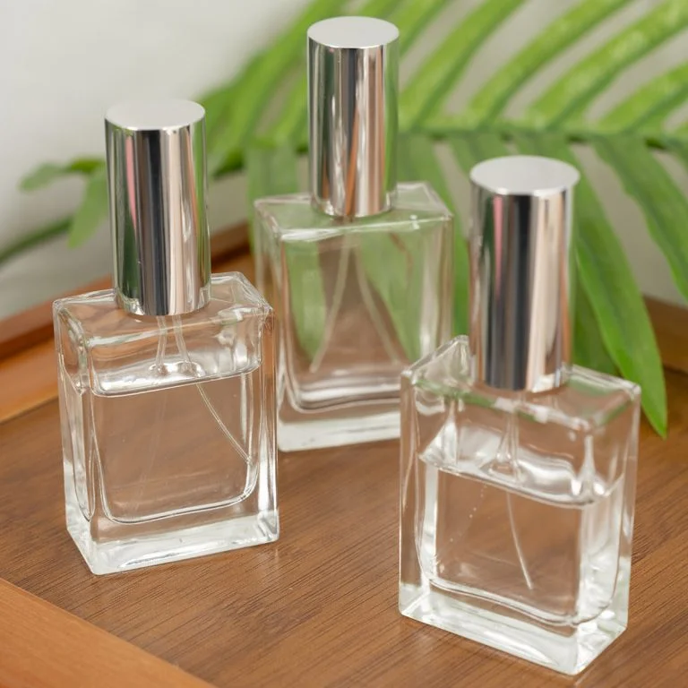 Clear square glass perfume bottles with silver spray caps