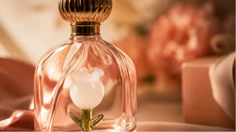 Close-up of a luxury perfume bottle featuring an inner glass rose