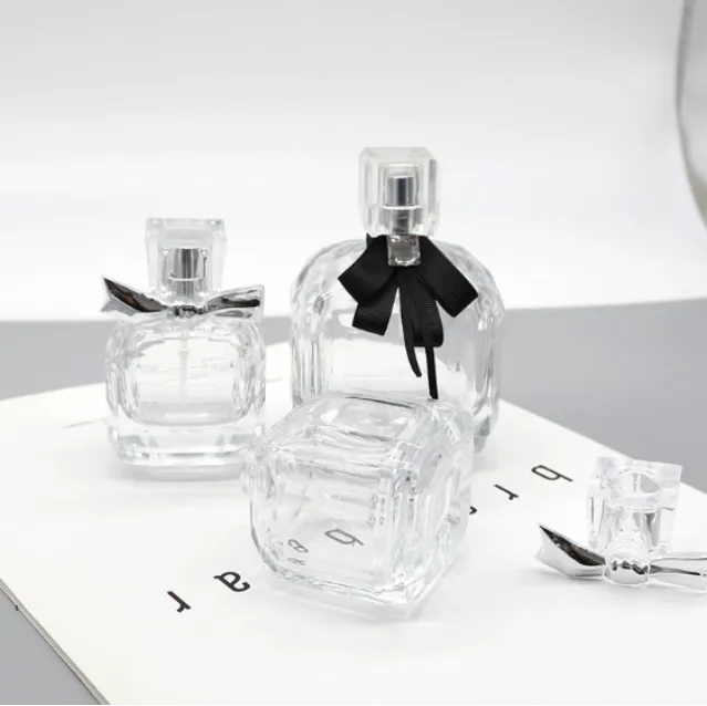 Clear glass perfume bottles with decorative bow ties