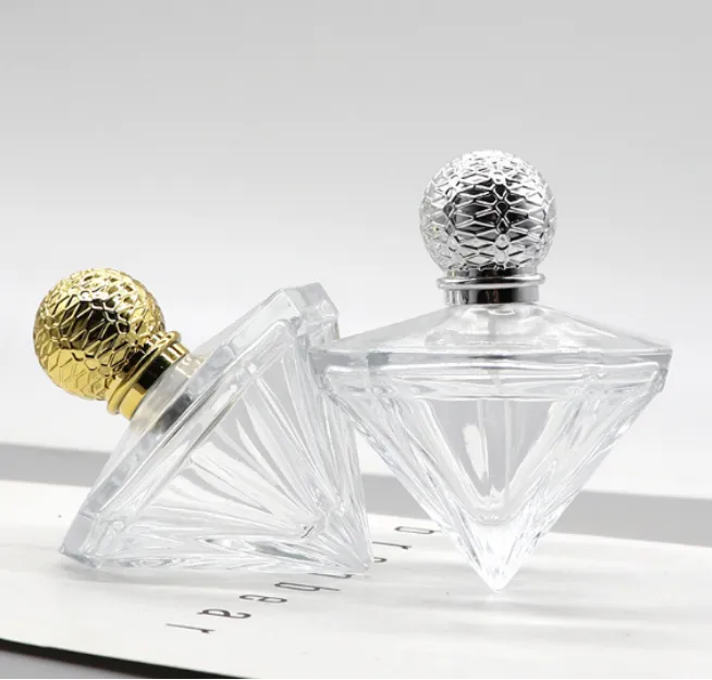 Diamond-shaped glass perfume bottles with textured round caps